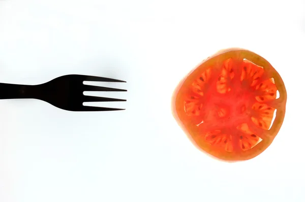 Garfo e tomate, com fundo — Fotografia de Stock