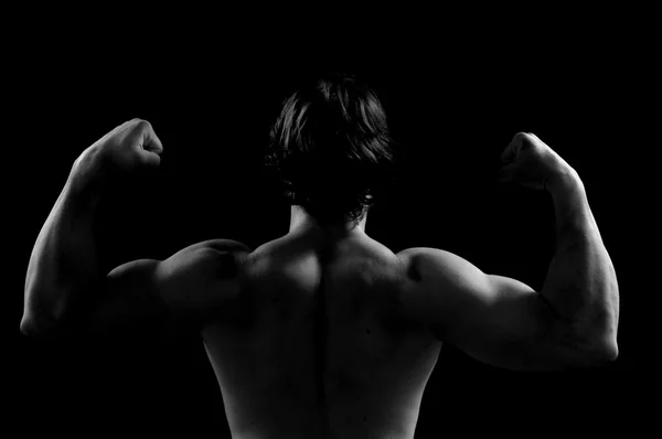 Silhouette of a man doing strength sword black background — Stock Photo, Image