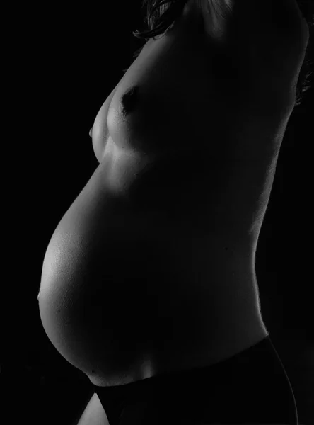 Femme enceinte avec fond noir — Photo