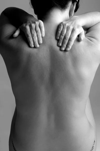 Nude woman with back pain — Stock Photo, Image