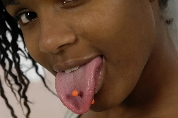 Teenage girl with a pierced tongue — Stock Photo, Image