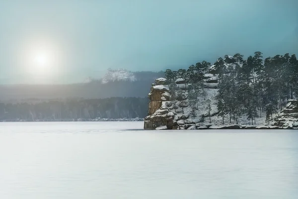 Rock in the middle of a frozen lake — Stock Photo, Image