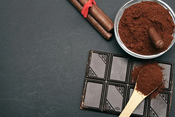 Kaffe och choklad på bakgrunden och färska staplade kaffe på träsked Stockfoto