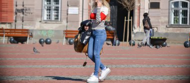 İnsanlar güneşli bir günde sokakta yürüyorlar. Gerçek insanlar..