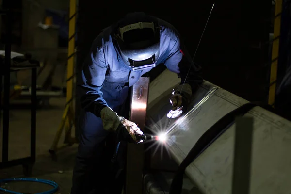 Metal workers use manual labor, Skilled welder, Factory workers making OT. Welder is welding the steel in the factory.