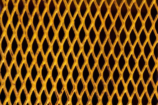 Yellow painted metallic plate anti slip surface. Metal diamond plate texture. yellow steel grating texture and background