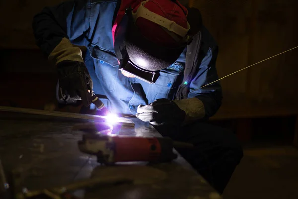 Metal workers use manual labor, Skilled welder, Factory workers making OT. Welder is welding the steel in the factory.