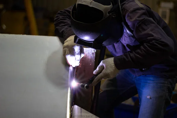 Metal workers use manual labor, Skilled welder, Factory workers making OT. Welder is welding the steel in the factory.