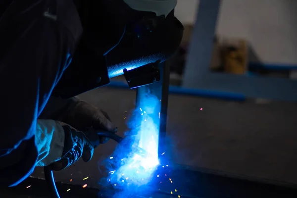 Metal workers use manual labor, Skilled welder, Factory workers making OT. Welder is welding the steel in the factory.