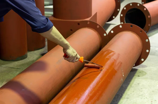 Rust-proof painted steel pipes in the factory. Red iron pipe