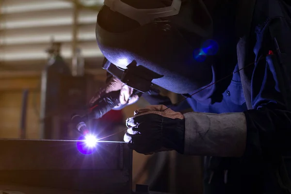 Metal workers use manual labor, Skilled welder, Factory workers making OT. Welder is welding the steel in the factory.