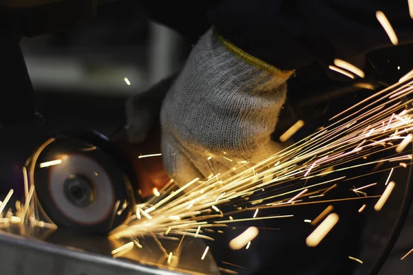 Metal workers use manual labor. Technicians use steel cutting tools to cut steel. Metal cutting. content work safety. builder wear fireproof gloves for safety at work.