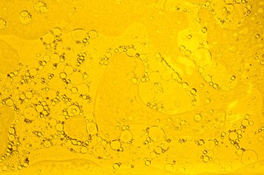 Sarı doku arka planı. Yağ suya düşer. Sarı baloncuk yağı.