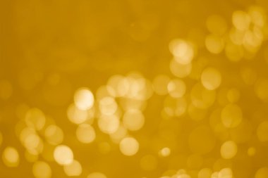 Sarı parıltılı klasik ışık arka planı. Sarı arkaplanda beyaz bokeh.