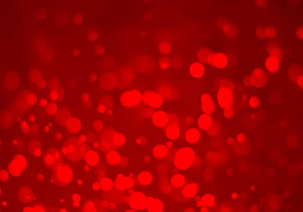 Red glitter vintage lights background. White bokeh on red background.