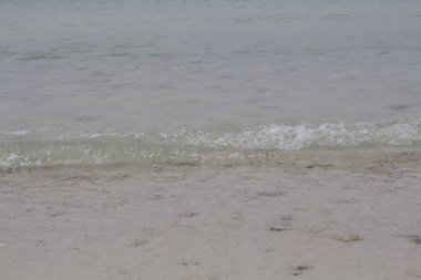 Deniz dalgası kum üzerinde. Fotoğraf.