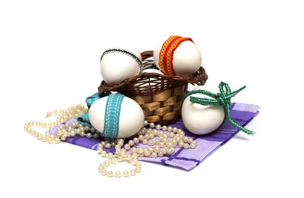 Easter holiday. Easter eggs with colored ribbon. Photo.