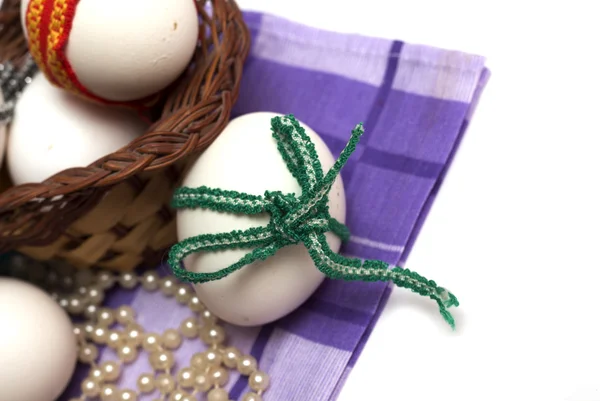 Easter holiday. Easter eggs with colored ribbon. Photo.