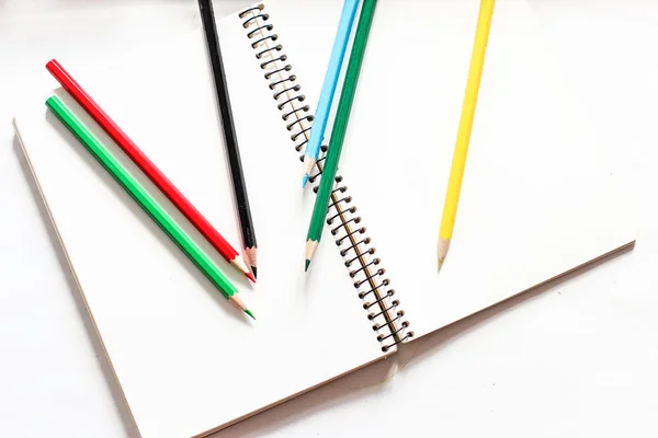 Color pencils with notebook — Stock Photo, Image