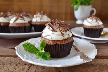 Krem ve ahşap backgrou çikolata ile çikolata cupcakes