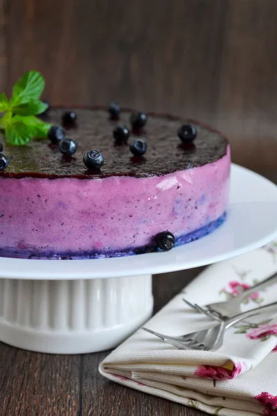 Blueberry mousse cake on a black background — Stock Photo, Image