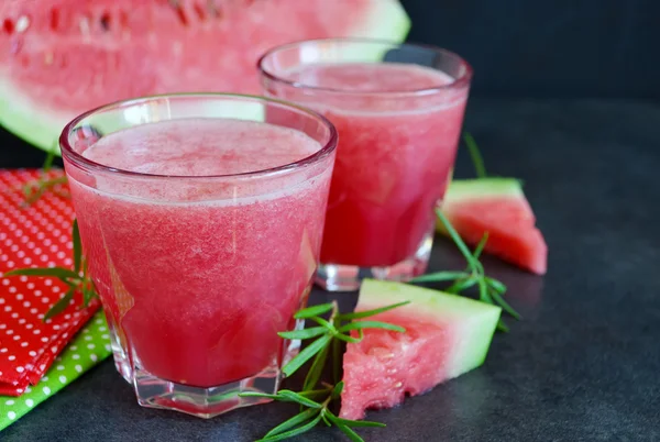 Summer cool drink,  juice of watermelon on a black background wi