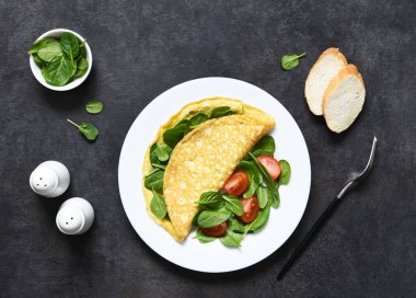Kahvaltı için ıspanaklı omlet beton kaplama bir tabakta. Metin için boşluk olan üst görünüm.