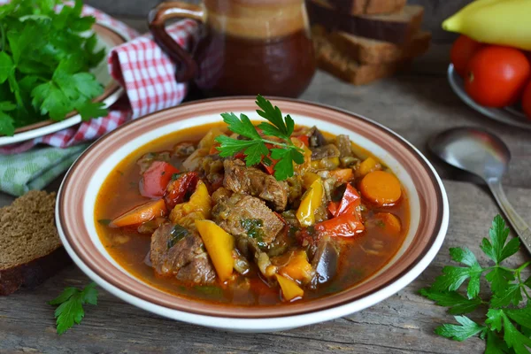 Meat stew with peppers, tomatoes and eggplant