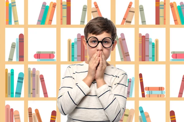 Studio shot of a funny  boy  in round glasses against the background of painted bookshelves. He is puzzled how to read all the books.  Education concept