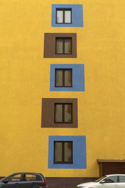 Modern bir Avrupa binasının pencereleri. Ön cephe çok renkli geometrik şekillerle boyanmıştır.