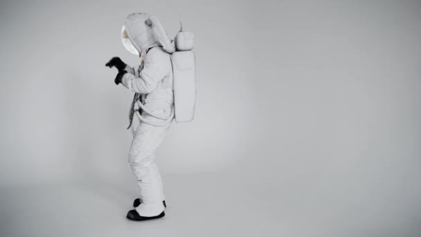 Astronaut v helmě tančící na lehkém pozadí. studio — Stock video