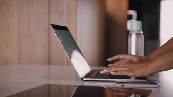 Hands of a young black girl are typing on a laptop. Work from home. — Stock Video