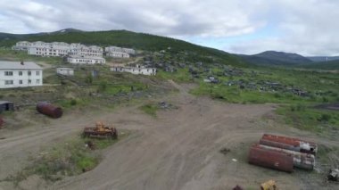 Terk edilmiş köyün hava manzarası. Köyde iki katlı evler ve bir katlı ahşap evler var. Birçok ev yıkıldı. Köyün etrafında bir sürü metal döküntüsü var..