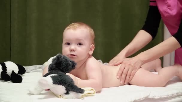 Masażystka Masuje Plecy Pośladki Dziecku Chłopcu Dziecko Leży Brzuchu Trzyma — Wideo stockowe