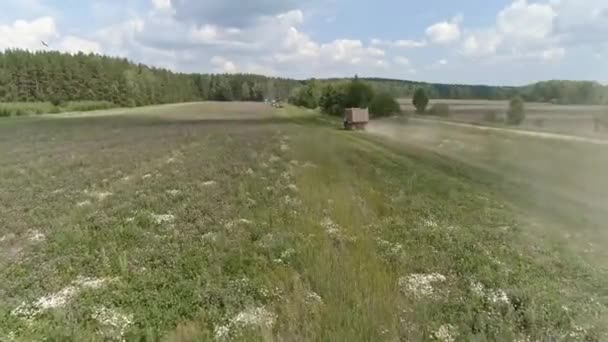 Aerial View Truck Driving Field Approaching Harvesters Forest Dirt Road — Stock Video