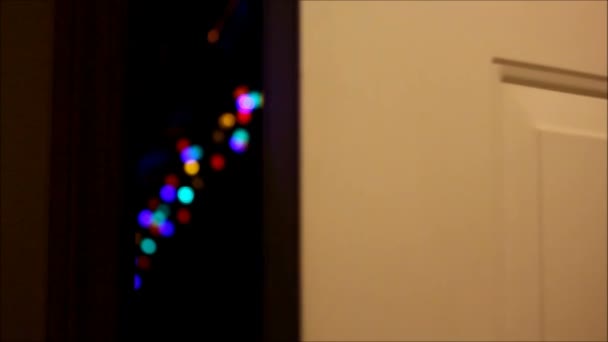 Door opens to show Christmas lights. — Stock Video