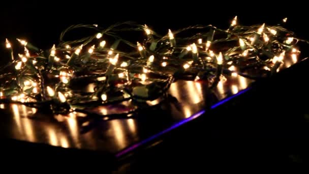 Lifting White Christmas Lights Off Of A Dark Table. Stock Video Lifting white Christmas lights off of a dark table. — Stock Video - Lifting White Christmas Lights Off Of A Dark Table. Stock Video