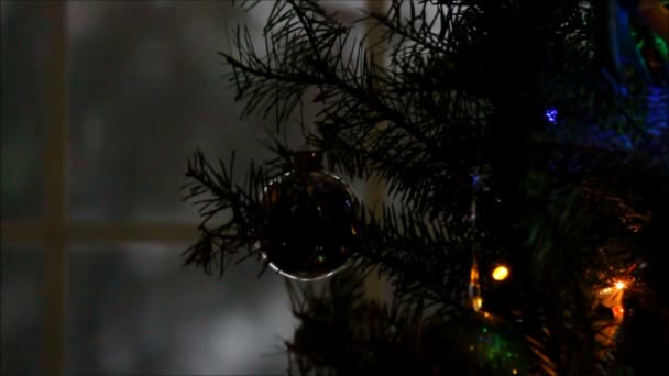Snow through the window dark Christmas decorations. — Stock Video