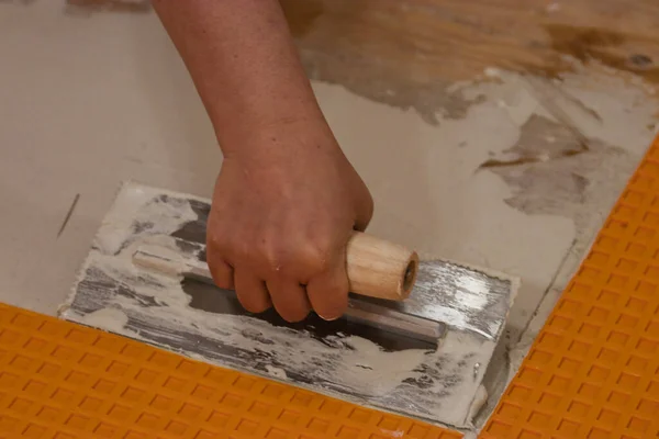 Using a flat square trowel to smooth and spread cement — Stock Photo, Image