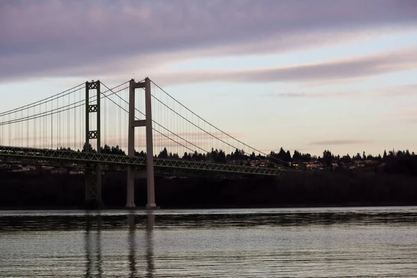 Ponte stretto in luce di sera sotto nuvole — Foto Stock