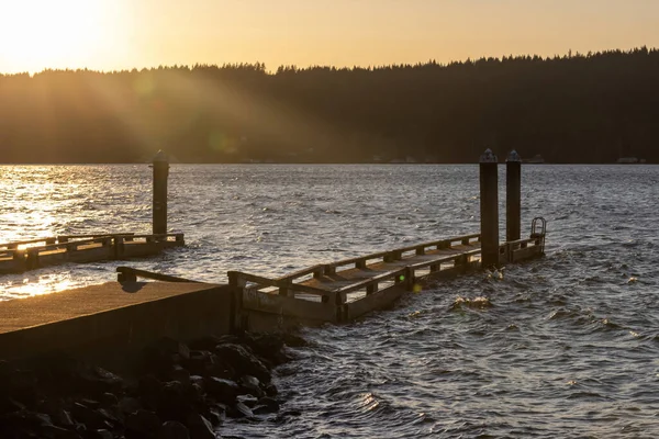 Late afternoon sun streaming over a dock at hood canal — Stock Photo, Image