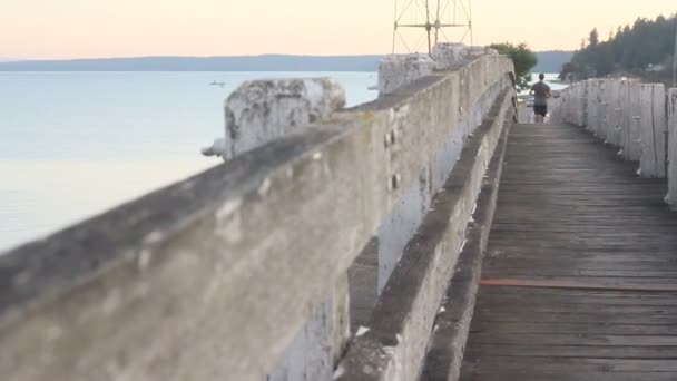 Jogging over wooden bridge — Stock Video