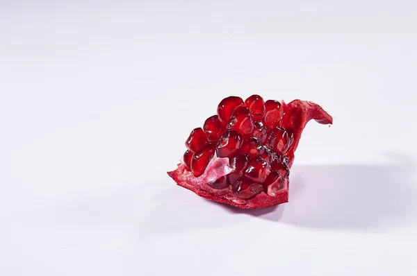 Beyaz arka plan üzerinde izole olgun nar meyve kesimi