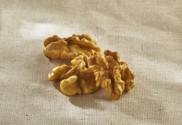 Walnuts on a light tablecloth — Stock Photo, Image