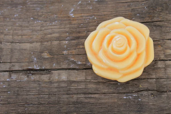 Soap in form a rose on wooden background — Stock Photo, Image