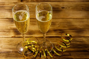 Ahşap masada iki kadeh şampanya.