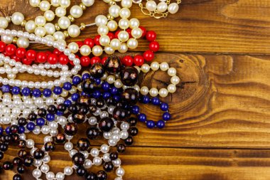 Ahşap arka planda farklı boncuk kolyeler