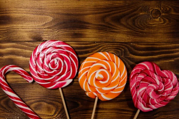 Kırsal ahşap arka planda tatlı lolipoplar. Üst görünüm