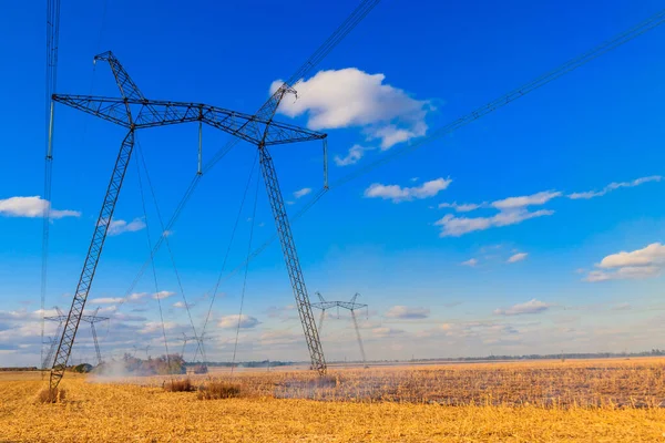High voltage power line against blue sky