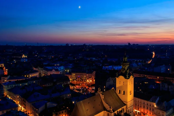 Aerial night view of illuminated Latin cathedral and Rynok square in Lviv, Ukraine. View from Lviv town hall